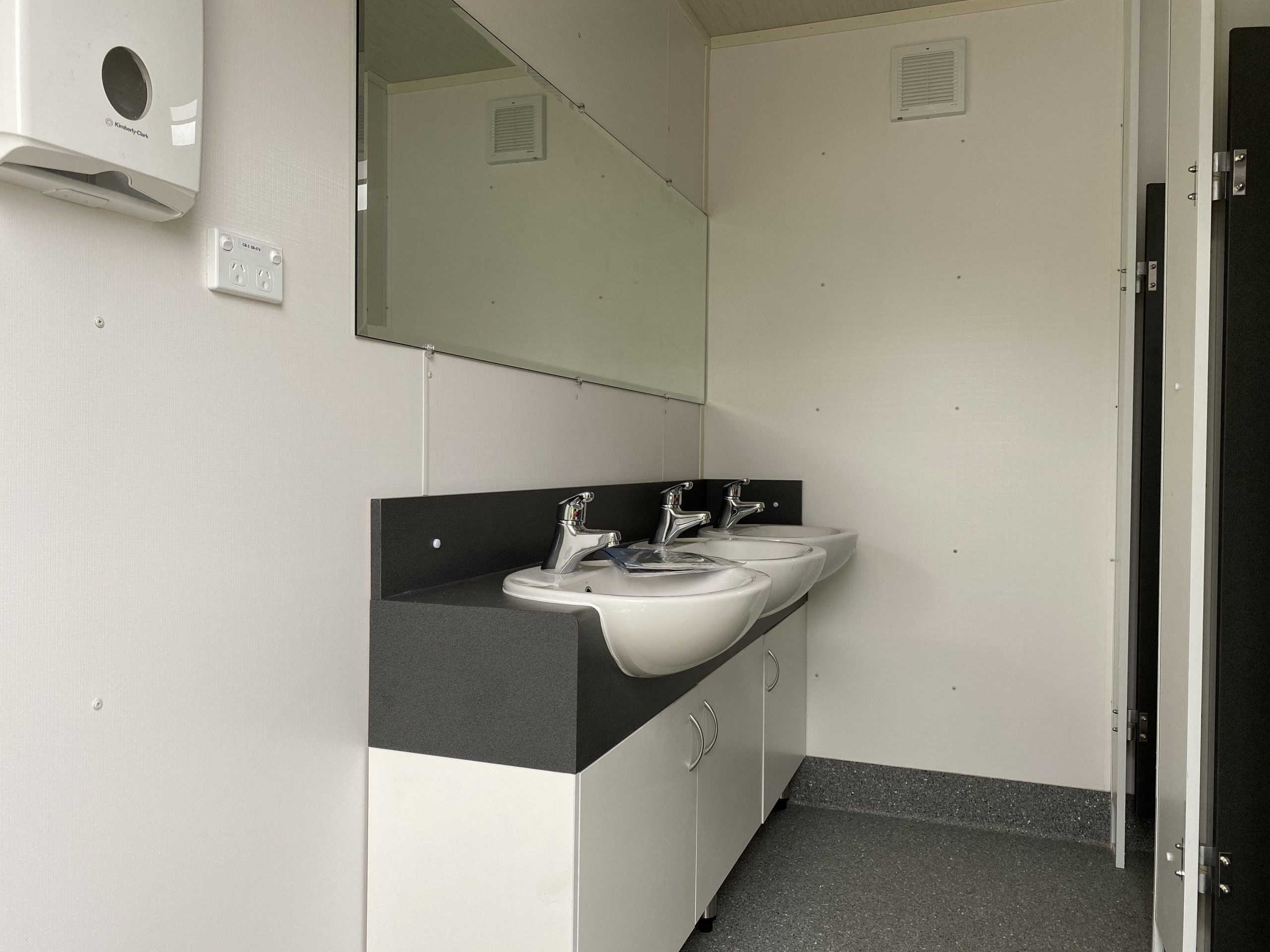 Upgraded vanity and sink in portable toilet building